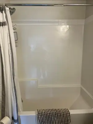 a bathroom with a bath tub with a shower curtain at Welcome to the Cozy Studio in Kelowna