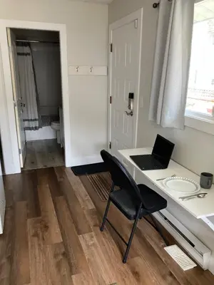 a room with a desk with a laptop on it at Welcome to the Cozy Studio in Kelowna