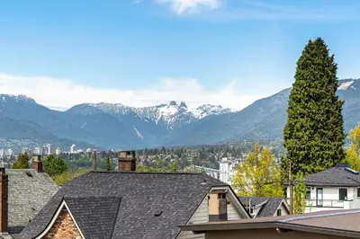 a view of snowy mountains from roofs of houses at Family-Friendly 3BR Home in Vancouver