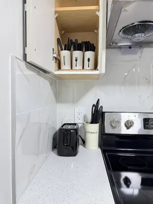 a small kitchen with a toaster and a stove at Range View Retreat/2BR Suite in Calgary