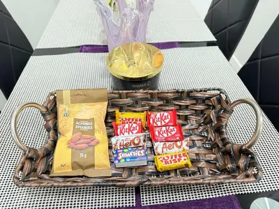 a basket of snacks on a table with a vase at Range View Retreat/2BR Suite in Calgary