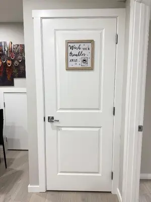 a white door with a sign on it at Range View Retreat/2BR Suite in Calgary