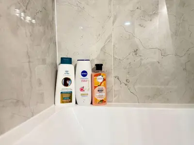 two bottles of cleaning products sitting on a bath tub at Range View Retreat/2BR Suite in Calgary