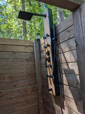 a wooden fence with a light on it at Creekside Bunkies in Roberts Creek