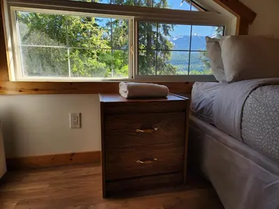 a bedroom with a bed and a large window at Alpenrose 4, Hottub, Mountains View, AC, sleep 5 in Golden