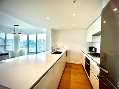 a kitchen with white counters and a large window at Central Stylish 3B2B near Richmond Center in Richmond