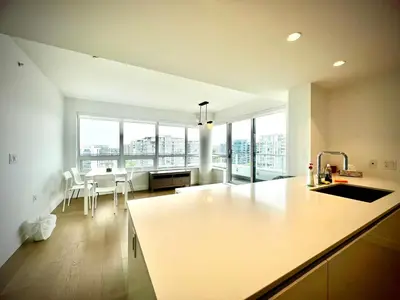 a kitchen with a counter and a table and some windows at Central Stylish 3B2B near Richmond Center in Richmond