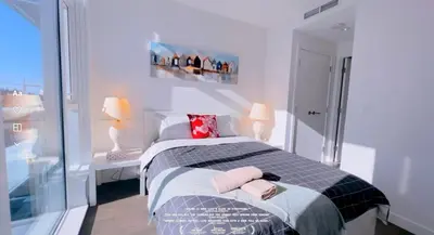 a bedroom with a bed with two towels on it at Central Stylish 3B2B near Richmond Center in Richmond