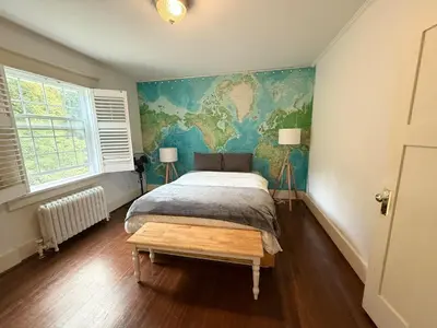 a bedroom with a bed and a mural on the wall at Spacious Villa 6BR 3 BA - Free Parking - Near Kitsilano Beach & Attractions - 15' to DT in Vancouver