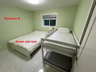 a bedroom with two bunk beds and a window at Newton Suite in Surrey
