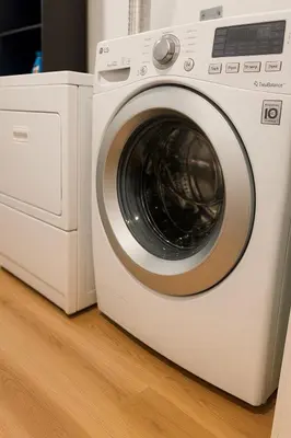 a white washer and dryer sitting on a wooden floor at Deep Cove holiday in North Vancouver