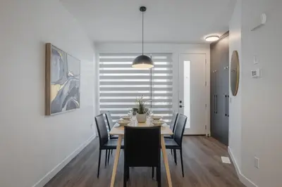 a dining room with a table and chairs at Fenced Yard, Free Parking, 2 King Beds with AC in Calgary