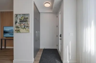 a hallway with white walls and a white ceiling at Fenced Yard, Free Parking, 2 King Beds with AC in Calgary