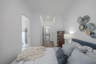 a bedroom with a bed with a blanket on it at Fenced Yard, Free Parking, 2 King Beds with AC in Calgary