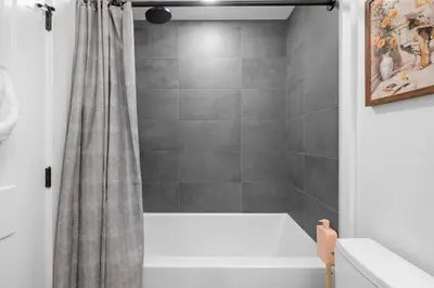 a bathroom with a shower with a shower curtain at Brand new suite downtown Kelowna - walk everywhere! in Kelowna