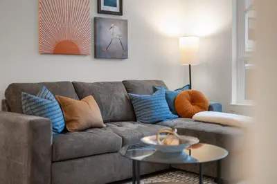a living room with a couch and a table at Chic Condo with Stylish Amenities in White Rock in Surrey