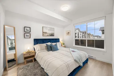 a bedroom with a bed and a window at Chic Condo with Stylish Amenities in White Rock in Surrey
