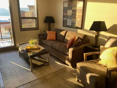 a living room with a couch and a table at PlayadelSol in Kelowna