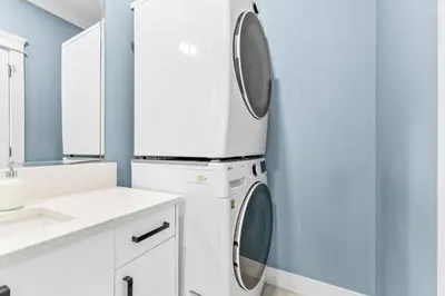 a white laundry room with a washer and dryer at Modern Private 3BR House in Vancouver