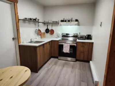 a kitchen with a sink and a stove top oven at Alpenrose 204 Hottubs, Mountains View, KING bed in Golden