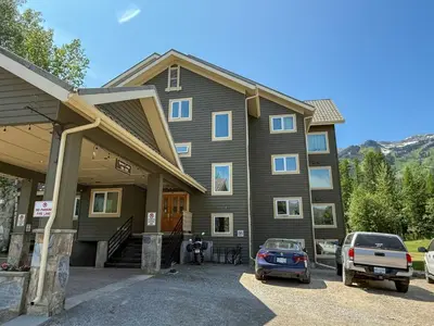 a large house with a car parked in front of it at Timberline - Spruce Lodge by Fernie Central Reservations in Fernie
