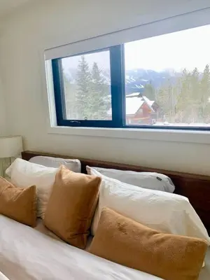 a bedroom with a bed with pillows and a window at The White House in Golden
