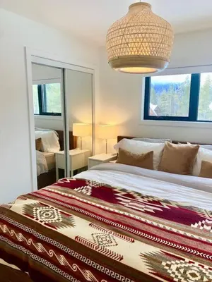 a bedroom with a large bed and a large mirror at The White House in Golden