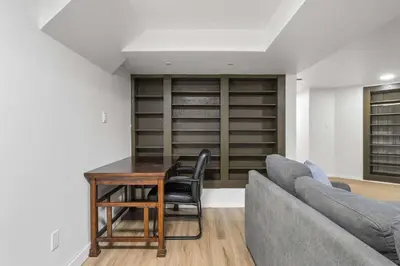 a living room with a table and a couch at Nineteen55 4BR Parkside Home in Central Red Deer in Red Deer