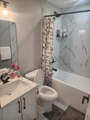 a bathroom with a toilet and a sink and a shower at Home in Northwest Calgary in Calgary