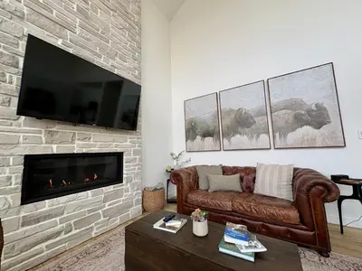 a living room with a couch and a fireplace at The Lamp House in Nordegg