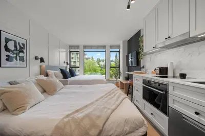 a bedroom with two beds and a kitchen at The Summit Room Whistler Village in Whistler