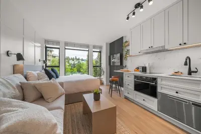 a kitchen and living room with a bed and a couch at The Summit Room Whistler Village in Whistler