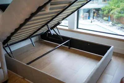 a bed in a room with a large window at The Summit Room Whistler Village in Whistler