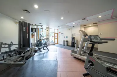 a gym with treadmills and machines in a room at The Summit Room Whistler Village in Whistler