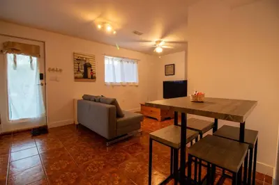 a living room with a table and a couch at Serene Garden Suite in Delta