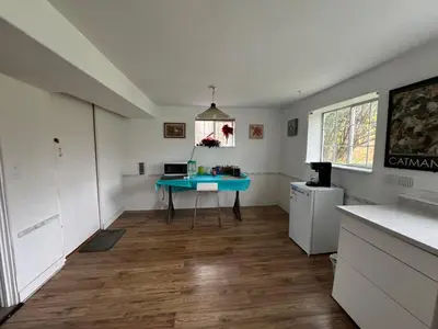 a kitchen with a blue table in the middle of a room at Surrey central in Surrey