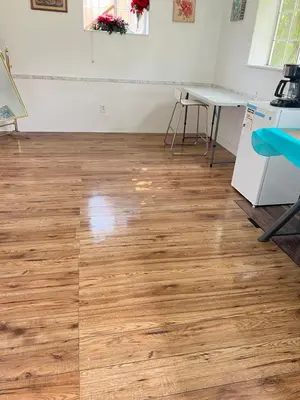 a room with a wooden floor and a table at Surrey central in Surrey