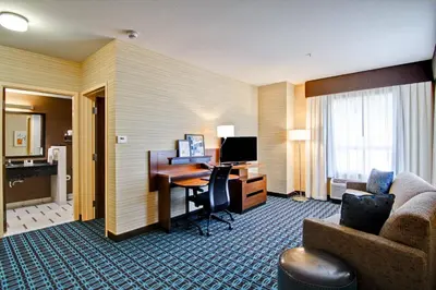 a hotel room with a desk and a computer at Fairfield Inn & Suites by Marriott Kamloops in Kamloops