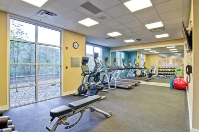 a gym with a row of treadmills and ellipticals at Fairfield Inn & Suites by Marriott Kamloops in Kamloops
