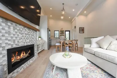 a living room with a couch and a fireplace at Luxury Saratoga Beach Town Home in Oyster Bay