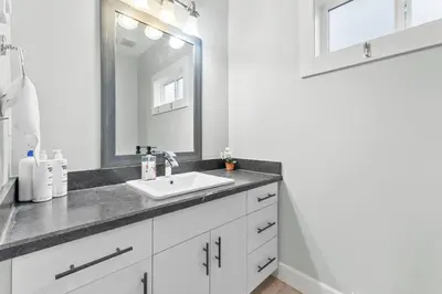 a bathroom with a sink and a mirror at Nanaimo 2BR Oceanview Suite w/ Kitchen & Laundry in Nanaimo