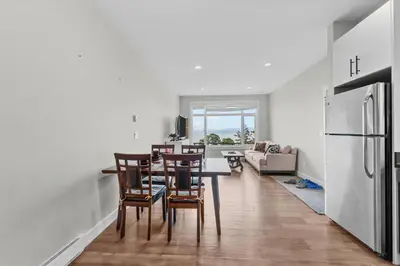 a kitchen and dining room with a table and chairs at Nanaimo 2BR Oceanview Suite w/ Kitchen & Laundry in Nanaimo