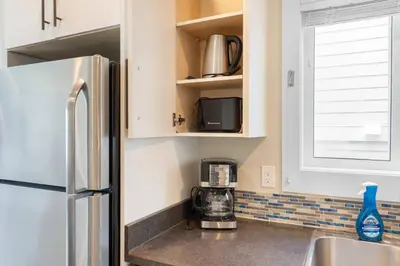 a kitchen with a refrigerator and a microwave at Nanaimo 2BR Oceanview Suite w/ Kitchen & Laundry in Nanaimo