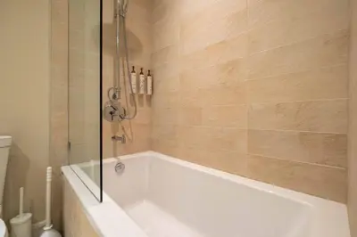 a white bath tub in a bathroom at Fitzsimmons Walk 16 by Outpost Whistler in Whistler