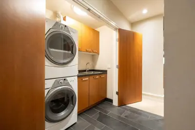 a laundry room with a washer and dryer at Fitzsimmons Walk 21 by Outpost Whistler in Whistler