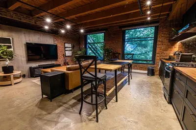 a kitchen with a table and chairs in a room at Stylish Industrial Loft - Historic Gastown in Vancouver