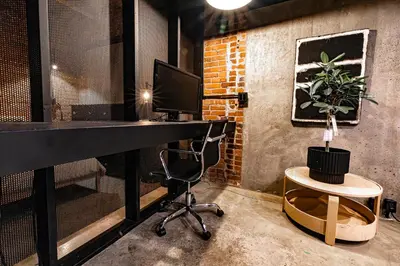 an office with a desk with a computer and a chair at Stylish Industrial Loft - Historic Gastown in Vancouver