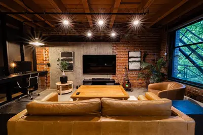 a living room with a couch and a table at Stylish Industrial Loft - Historic Gastown in Vancouver