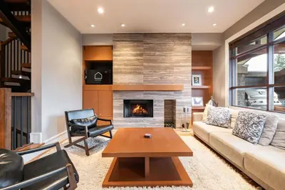 a living room with a couch and a fireplace at Fitzsimmons Walk 26 by Outpost Whistler in Whistler