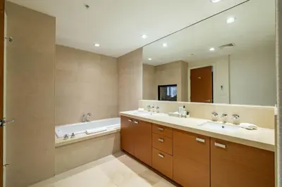 a bathroom with two sinks and a tub and a large mirror at Fitzsimmons Walk 26 by Outpost Whistler in Whistler
